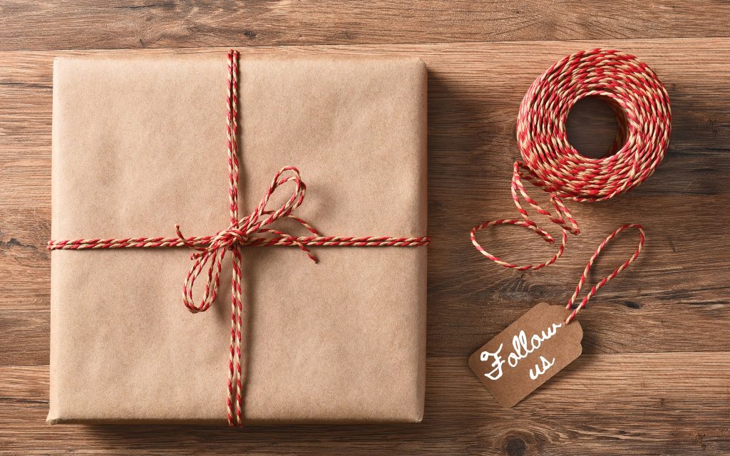 Box wrapped in brown paper with red and white string